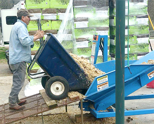 Schweiss Conveyor getting a wheelbarrow dumped into it