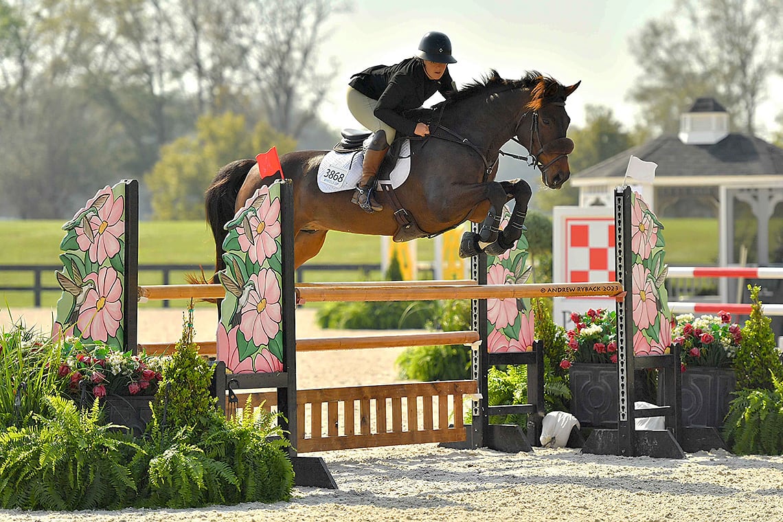 Autumn Schweiss going over a jump with her horse during the show jumping phase