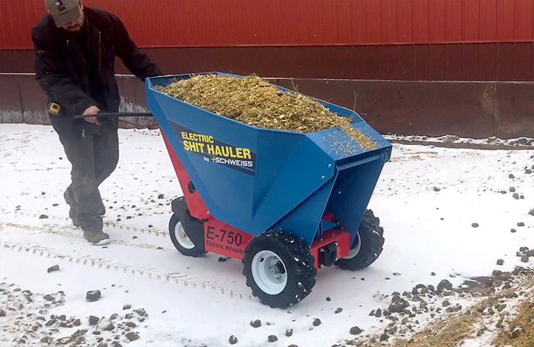 A Schweiss employee test the Electric Manure Hauler